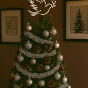 Celebrate the season with this handcrafted Christmas tree topper featuring a graceful silver dove in flight—symbolizing peace, hope, and renewal. Nestled among shimmering silver garland and coordinating ornaments, its celestial silhouette adds a serene, elegant focal point to your holiday décor, perfect for modern, rustic, or symbolic themes. Valentine gift idea present.