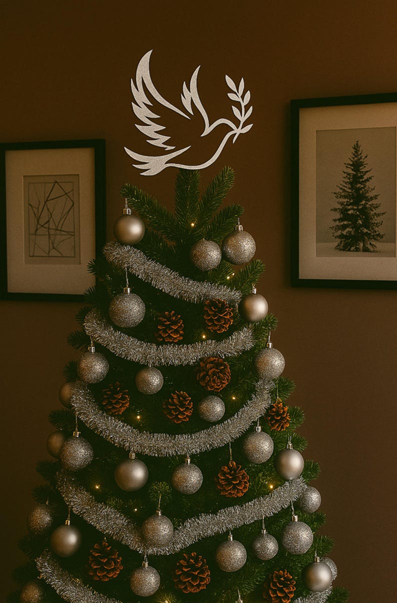 Celebrate the season with this handcrafted Christmas tree topper featuring a graceful silver dove in flight—symbolizing peace, hope, and renewal. Nestled among shimmering silver garland and coordinating ornaments, its celestial silhouette adds a serene, elegant focal point to your holiday décor, perfect for modern, rustic, or symbolic themes. Valentine gift idea present.