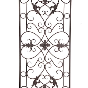 May include: Ornate, dark brown metal decorative panel with a rectangular frame. The design features symmetrical scrollwork, floral accents, and a central four-leaf clover motif. The panel is suitable for interior or exterior use.