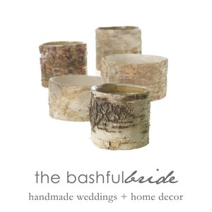 May include: Four natural birch bark cylinder vases, perfect for rustic wedding centerpieces or home decor. The vases are made of real birch bark and have a natural, rustic look.