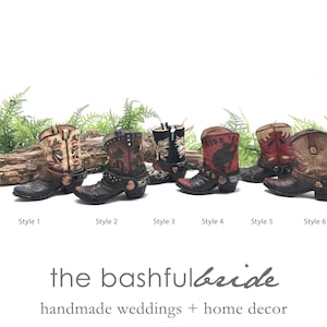 May include: Six different styles of cowboy boot planters, each with a unique design and color scheme. The boots are made of ceramic and have a rustic, vintage look. They are perfect for adding a touch of Western charm to your home decor.
