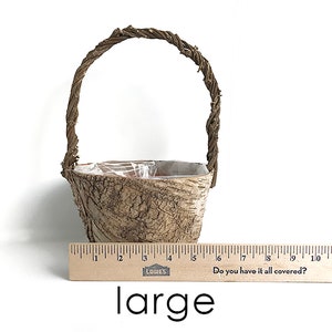 May include: A large, brown, woven basket with a handle. The basket is made of natural materials and has a rustic look. The basket is about 6 inches tall and 5 inches wide.