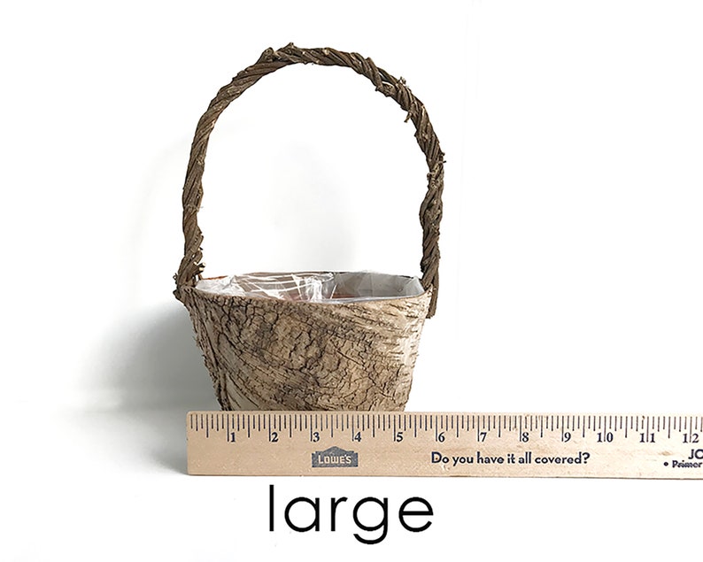May include: A large, brown, woven basket with a handle. The basket is made of natural materials and has a rustic look. The basket is about 6 inches tall and 5 inches wide.