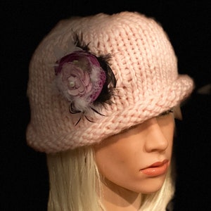 Roze clochehoed met opgerolde rand voor dames.