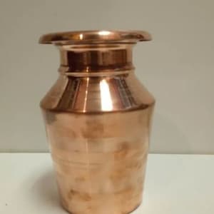 May include: A small copper vase with a rounded body and a flared top. The vase has a smooth, polished finish.