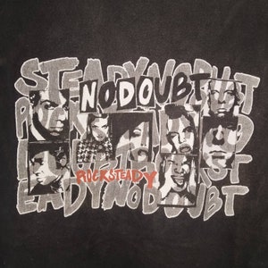 May include: Black and white graphic print of a band called "No Doubt" with the words "RockSteady" printed below. The band members are in black and white and are arranged in a grid pattern. The background is black.