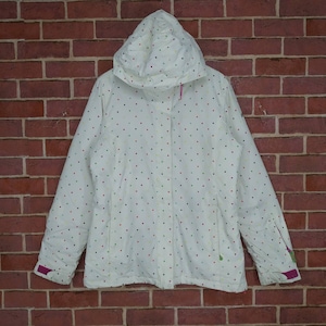 May include: White hooded jacket with a colourful polka dot pattern. The jacket has a zip closure and pink accents on the sleeves and hood.