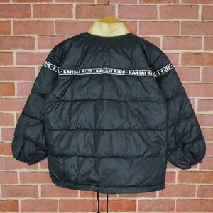 May include: Black puffer jacket with a yellow lining and a white band around the bottom with the text "KANSAI KIDS" repeated.
