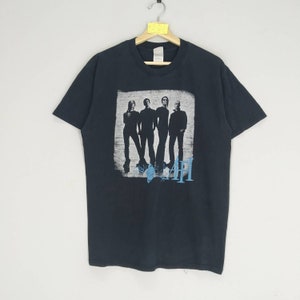 May include: Black t-shirt with a band graphic of AFI. The band members are silhouetted in black and white, with the band name in blue.