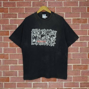 May include: Black t-shirt with a graphic print of the band No Doubt. The print features the band members' faces in black and white, with the band's name in white and red lettering.