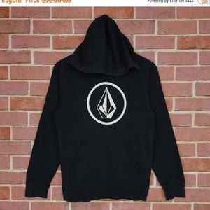 May include: Black hooded sweatshirt with a white diamond logo in a circle on the front.