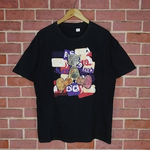 May include: Black t-shirt with a graphic print of a cartoon robot wearing a hat and sitting down. The graphic includes the text "Astro Boy" and "Super Robot".