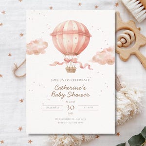 May include: A baby shower invitation featuring a watercolor illustration of a pink hot air balloon with a basket, ribbons, and clouds. The invitation includes the text "Join us to celebrate Catherine's Baby Shower" and event details for August 30, 2025.