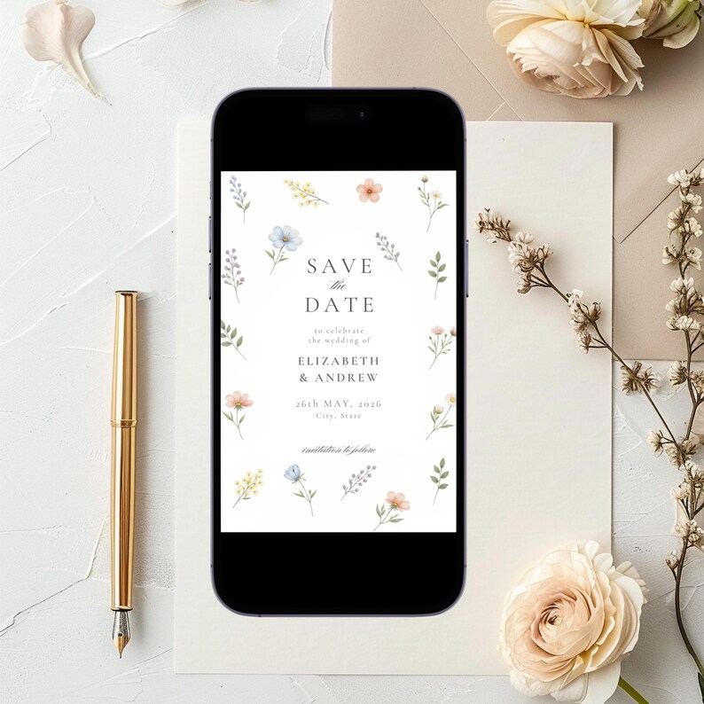 May include: A smartphone displaying a digital Save the Date card with watercolor floral illustrations. The text reads Save the Date to celebrate the wedding of Elizabeth & Andrew 26th May, 2026. The design features small blue, pink, and yellow flowers.