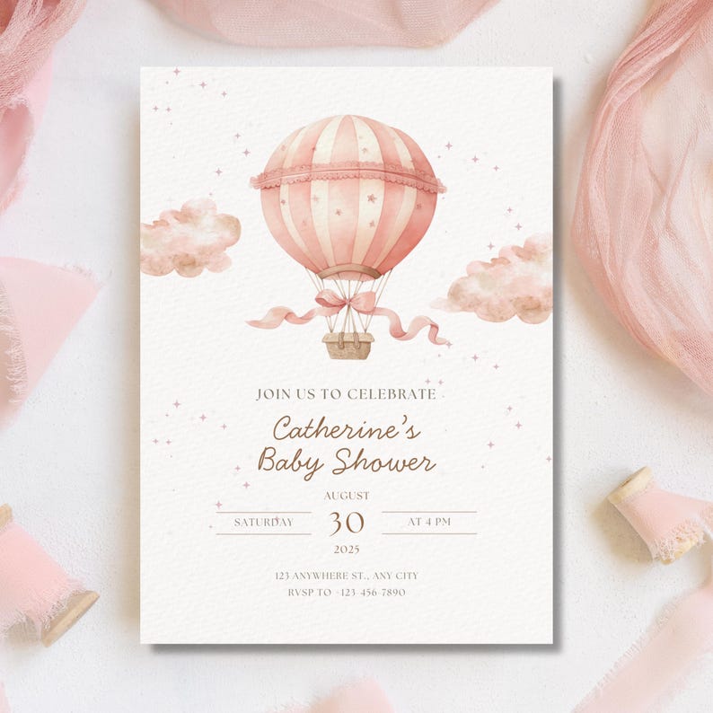 May include: A baby shower invitation featuring a watercolor illustration of a pink hot air balloon, clouds, and stars. The invitation includes the text "Catherine's Baby Shower" with the date, time, and RSVP information.