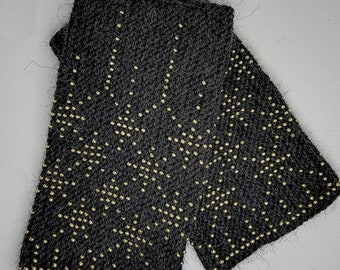 Handknitted wrist warmers with beads.