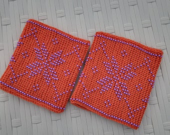 Handknitted orange wrist warmers with beads.