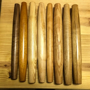 In this image are (from left to right) walnut, mahogany, ash, maple, cherry, red oak, white oak, and hickory.