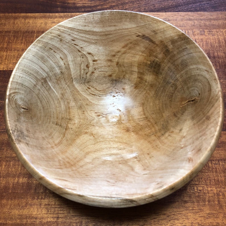K&ouml;nnte beinhalten: Eine gro&szlig;e Holzsch&uuml;ssel mit nat&uuml;rlicher Holzoptik. Die Sch&uuml;ssel ist aus hellem Holz mit einer Maserung gefertigt. Die Sch&uuml;ssel ist leer und bereit f&uuml;r den Gebrauch.
