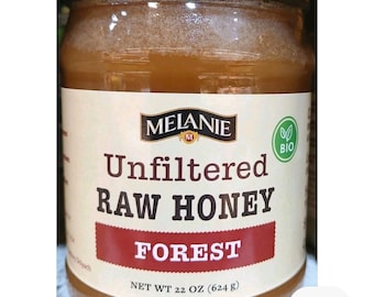 May include: A glass jar of unfiltered raw honey labeled "FOREST" with a net weight of 22 oz (624 g). The label features the brand name "MELANIE" and a "BIO" logo.