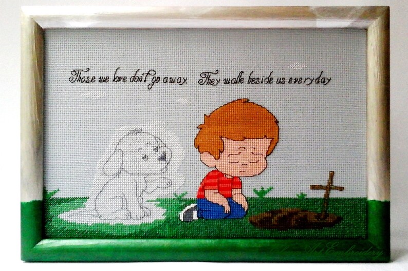 K&ouml;nnte beinhalten: Eine gerahmte Kreuzstich-Stickerei mit einem Jungen, der neben einem kleinen Grab mit einem Kreuz kniet. Der Junge schaut mit traurigem Ausdruck nach unten. Ein schwaches Bild eines Hundes befindet sich hinter ihm. Der Text lautet "Those we love don't go away. They walk beside us everyday."