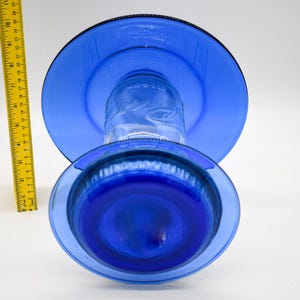 Top view of royal blue glass bird feeder showing upper weather shield and lower glass plate
