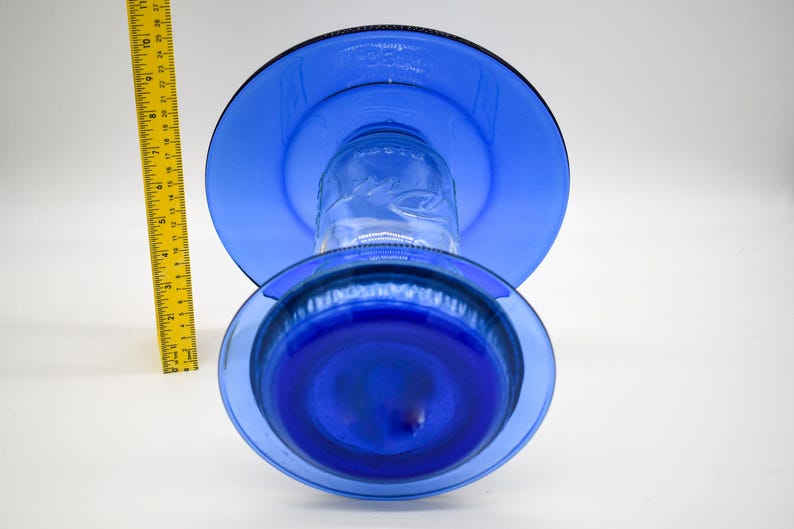 Top view of royal blue glass bird feeder showing upper weather shield and lower glass plate