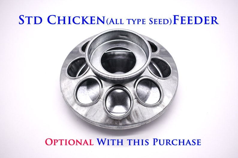 May include: A silver metal chicken feeder with a round base and multiple circular openings for seed. The feeder has a central ring for holding seed. The text "STD CHICKEN (ALL TYPE SEED) FEEDER" is printed in blue on a white background.