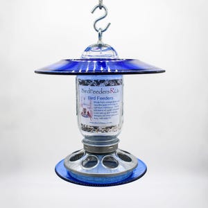 Royal blue glass hanging bird feeder with clear Mason jar and galvanized metal seed base