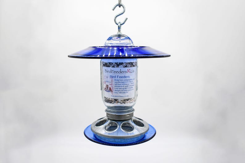 Royal blue glass hanging bird feeder with clear Mason jar and galvanized metal seed base