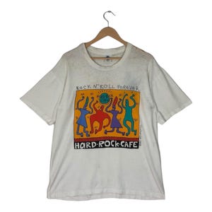 T-shirt vintage anni '90 Hard Rock Cafe di Big Hed Design 1992 / Maglietta grafica "Rock & Roll Forever" - Stile Keith Haring / Bianco anticato, taglia L