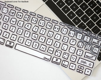 May include: A clear keyboard cover with black outlined keys for a MacBook. The cover has a handwritten font and the text "iDecal" is printed on the space bar.