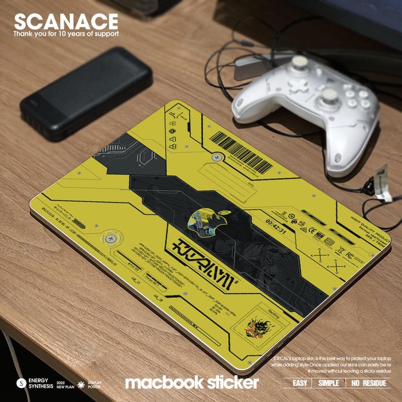 May include: A yellow and black laptop skin with a futuristic design and the text "SCANACE" and "macbook sticker". The skin features a black and white illustration of a robot with the text "ROZAIYVI" in Japanese characters.