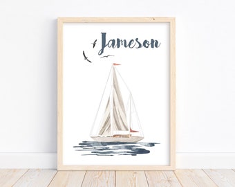 May include: A framed print with a watercolor illustration of a sailboat with a red sail and blue water. The name "Jameson" is written in black script above the sailboat.