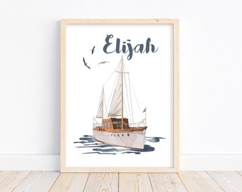 May include: A framed print with a watercolor illustration of a sailboat on the water with the name Elijah written in blue cursive above the boat.