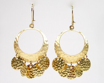 May include: Gold tone dangle earrings with a hammered hoop and multiple small round charms.