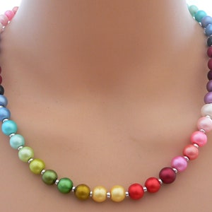 May include: A rainbow colored beaded necklace with silver beads separating each colored bead.