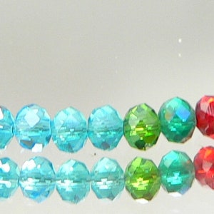 May include: Two strands of colorful, faceted beads in a rainbow of colors. The beads transition from red to orange, yellow, green, blue, and purple. The beads are strung together, creating a vibrant and eye-catching accessory.