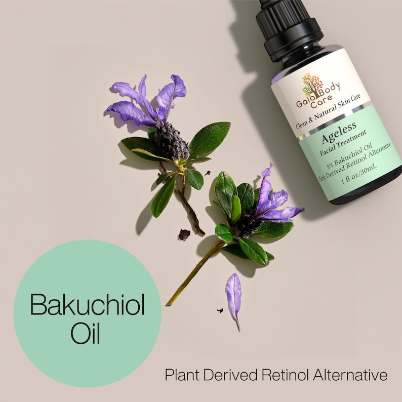 May include: A glass bottle of Ageless Facial Treatment with 5% Bakuchiol Oil, a plant-derived retinol alternative. The bottle is labeled with the brand name Gaia Body Care and has a green and white label. The bottle is sitting on a light brown surface with purple flowers.