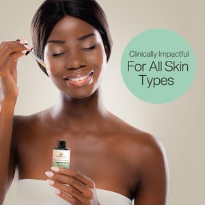 May include: A woman with dark skin is applying a clear serum from a glass bottle with a dropper. The bottle is labeled "Simply Beauty Care" and "Ageless". The text "Clinically Impactful For All Skin Types" is written in a circle on a light green background.