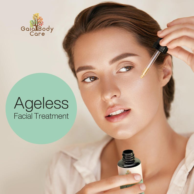 May include: A woman applies a facial treatment serum from a bottle labeled "Ageless Facial Treatment" by Gaia Body Care. The bottle is black with a dropper and a green label with a tree illustration.
