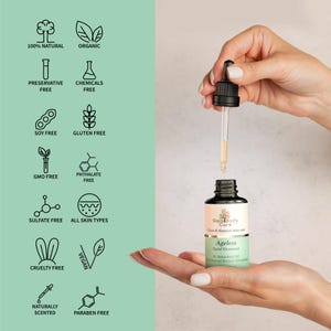 May include: A glass bottle of Ageless Facial Treatment by Gaia Body Care. The bottle is labeled with the text "Clean & Natural Skin Care" and "Ageless Facial Treatment 30 Bakuchiol Oil for Improved Retinol Alternative". The bottle has a dropper and is being held by a hand. The bottle is surrounded by icons that indicate the product is 100% natural, organic, preservative free, chemical free, soy free, gluten free, GMO free, phthalate free, sulfate free, cruelty free, vegan, naturally scented, and paraben free.