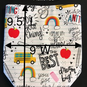 May include: A white fabric tote bag with a school-themed design. The bag features a variety of colorful illustrations, including rainbows, school buses, apples, and pencils. The bag is 9.5 inches tall and 9 inches wide. The text on the bag reads "Do your thing!" "Speak Up and Be Heard!" "You're the Best!" "You got this!" "Dream Big!" and "I can do anything!"