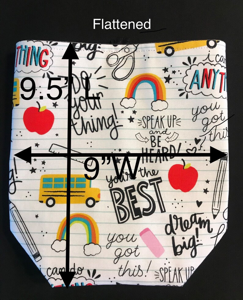 May include: A white fabric tote bag with a school-themed design. The bag features a variety of colorful illustrations, including rainbows, school buses, apples, and pencils. The bag is 9.5 inches tall and 9 inches wide. The text on the bag reads "Do your thing!" "Speak Up and Be Heard!" "You're the Best!" "You got this!" "Dream Big!" and "I can do anything!"
