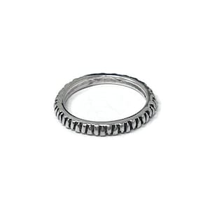 May include: A silver ring with a textured band.