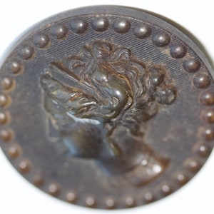Woman&#39;s Head on Horn