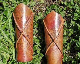 Fold formed heat patinated copper armor vambraces. Hand made one of a kind gift made in Canada. Comes as a pair.