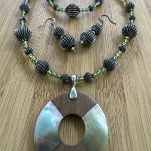 wood and shell pendant, metal and glass beads