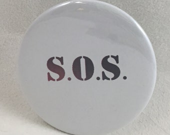 2 1/4" pinback button. But who's gonna save us is the question...