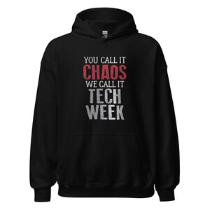 May include: Black hooded sweatshirt with the text "You call it chaos, we call it tech week" in red and white lettering.